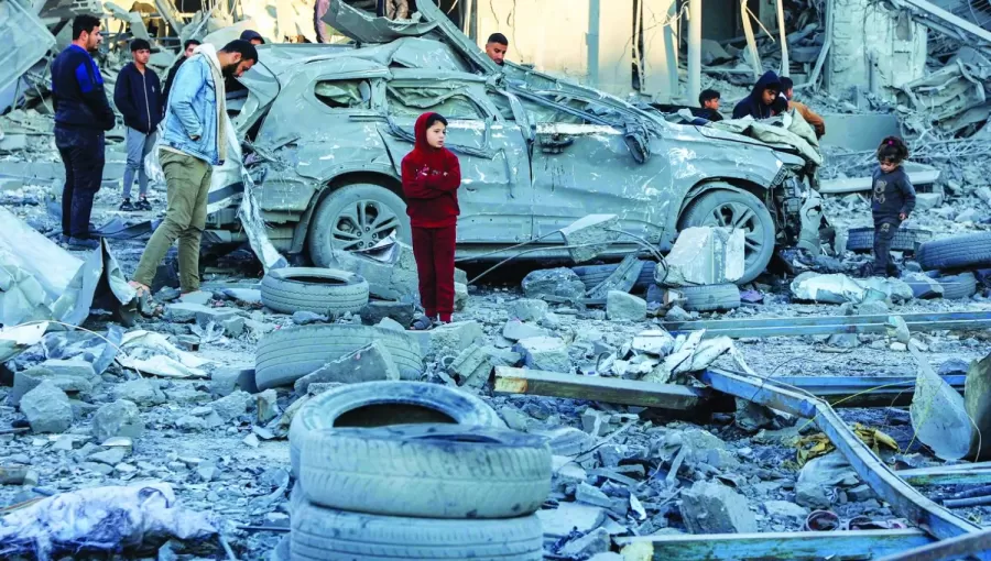 فلسطينيون يقفون أمام سيارة مدمرة وسط أنقاض مبنى منهار بعد قصف إسرائيلي في مدينة غزة فلسطينيون يقفون أمام سيارة مدمرة وسط أنقاض مبنى منهار بعد قصف إسرائيلي في مدينة غزة 14/1/2025 | المصدر: وكالة الأنباء الفرنسية