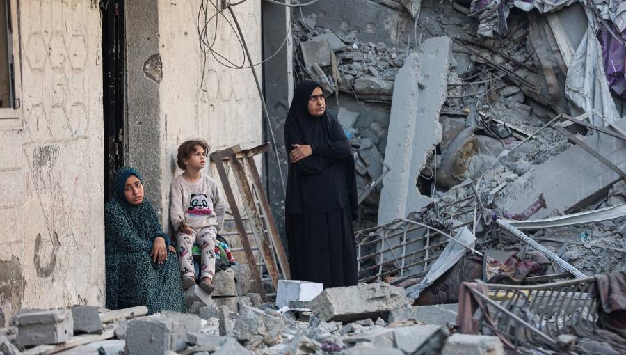 امرأتان وطفلة وسط أنقاض منزل دمرته غارات الاحتلال على غزة | وكالة الأنباء الفرنسية