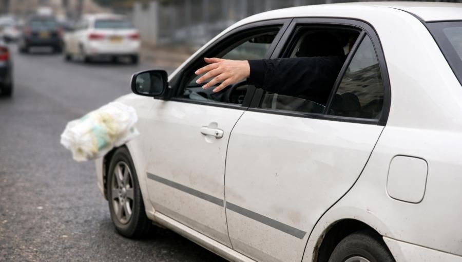 صورة مولدة بالذكاء الاصطناعي لشخص يرمي النفايات من نافذ السيارة