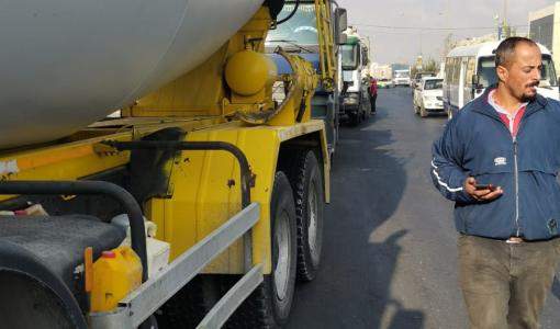 صورة لتوقيف رقيب سير لعدّة شاحنات ثقيلة لمخالفتها أوقات سيرها على بعض الطرقات بالعاصمة عمان