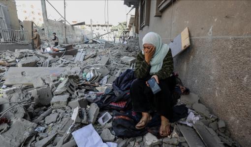 امرأة تجلس على ركام بيتها في غزة