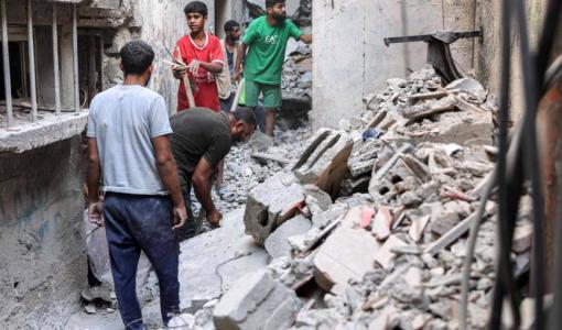 رجال يبحثون بين أنقاض منزل شقيقة إسماعيل هنية الذي استهدفه الاحتلال | المصدر: وكالة الأنباء الفرنسية