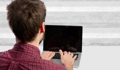 شاب يستخدم حاسوبا محمولا شاب يستخدم حاسوبا محمولا | تعبيرية Freepik