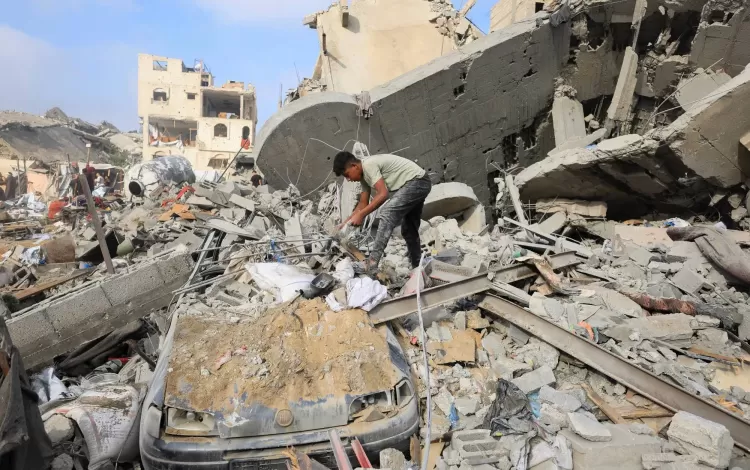 طفل فلسطيني يتفقد موقع الغارة الإسرائيلية التي استهدفت مدينة غزة | رويترز